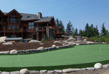 Large house with backyard putting green synthetic turf